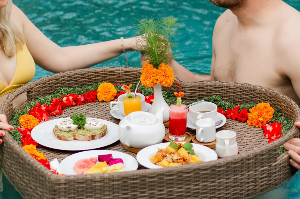 Floating breakfast tray of fruit, pastries and juice served in the pool