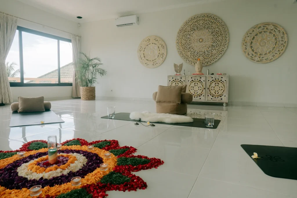 Bright retreat room with carved wooden wall panels and a flower mandala on the floor