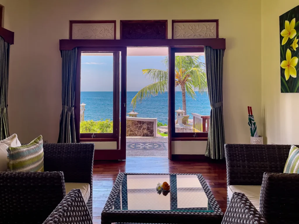 Seafront lawn and loungers framed by magenta bougainvillea