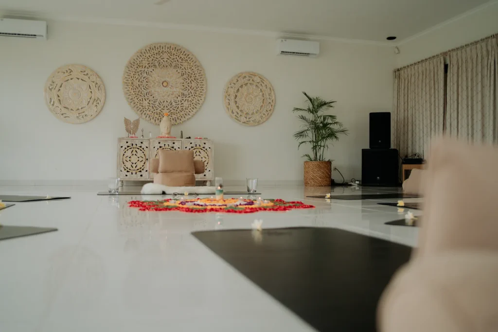 Retreat room floor with mats and a flower mandala, shot low across the room